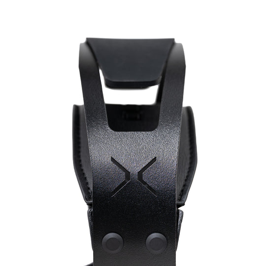 Close-up of a black textured strap with a debossed 'X' logo and two snap buttons, shown against a plain white background.